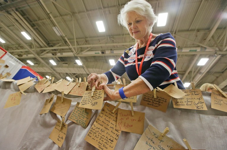 Emily McBurney places notes of thanks for Texas Sen. Ted Cruz and his wife that supporters wrote during the Texas Republican Convention Thursday, May 12, 2016, in Dallas. (AP Photo/LM Otero)
