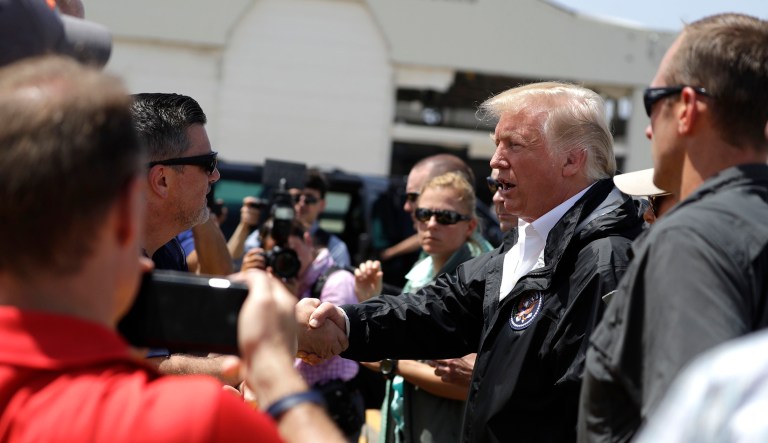 President Trump greets people on his arrival at the Luis Muñiz Air National Guard Base in San Juan, Puerto Rico, Tuesday, Oct. 3, 2017. Trump visited Puerto Rico in the wake of Hurricane Maria. (AP Photo/Evan Vucci)