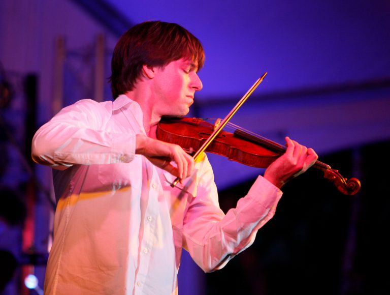 In this July 17, 2010 file photo, violinist Joshua Bell plays his Stradivarius violin from 1713 at the Far Niente winery during its 125th anniversary celebration in Oakville, Calif. The Grammy-winning violinist played for spare change in a D.C. Metro station during a 2007 experiment with The Washington Post, and almost no one paid attention. Now, Bell tells the Post he is planning another public performance in the main hall at Washington's Union Station set for Sept. 30, 2014.  (AP Photo/Eric Risberg, file)
