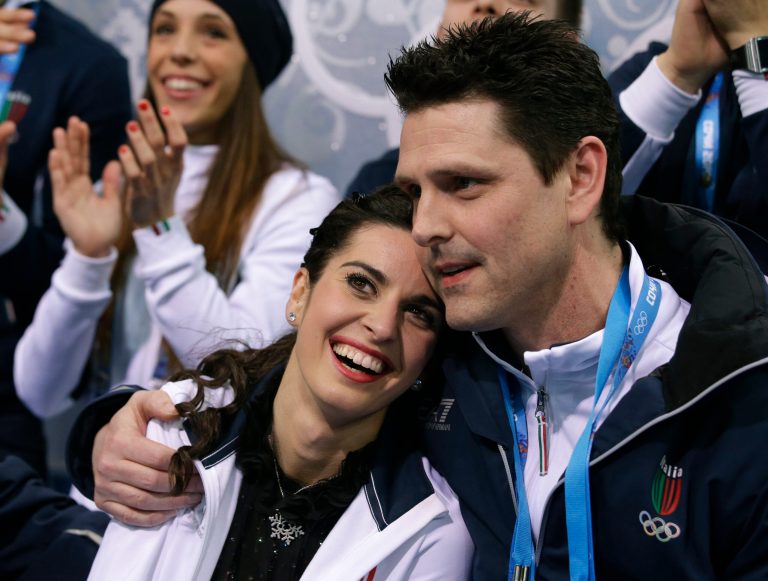 Valentina Marchei of Italy, left, is embraced by a team member as she waits in the results area after competing in the women's team free skate figure skating competition at the Iceberg Skating Palace during the 2014 Winter Olympics, Sunday, Feb. 9, 2014, in Sochi, Russia. (AP Photo/Darron Cummings, Pool)