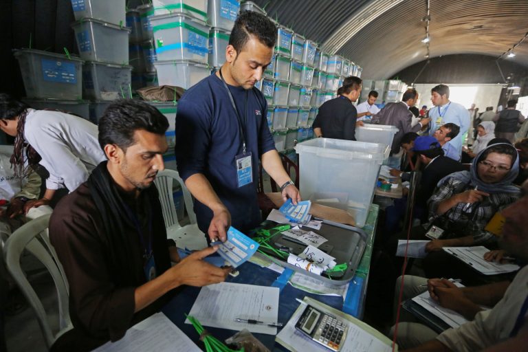 Afghan election commission workers sort ballot papers for an audit of the presidential run-off votes at an election commission office in Kabul, Afghanistan, Sunday, Aug. 3, 2014. An audit of results from Afghanistan's presidential runoff election resumed Sunday after a holiday break, an electoral official said. (AP Photo/Rahmat Gul)