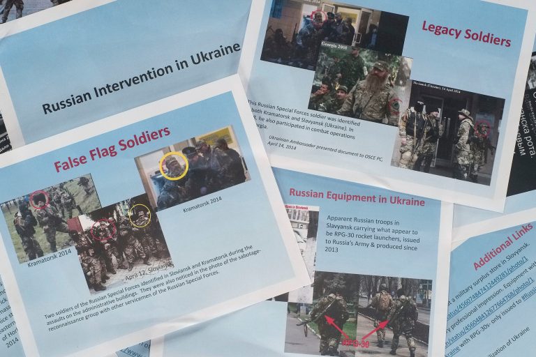 These printed copies of a presentation released by the U.S. Department of State on Thursday, April 17, 2014, purport to show Russian involvement in Eastern Ukraine. The 11-page document contains images of soldiers in eastern Ukraine that the State Department says are Russian forces, showing militants wearing similar uniforms and brandishing Russian weapons. There was no way to immediately verify the photographs, which the State Department says were taken from the Internet and social media. (AP Photo)