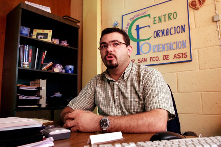 FILE - In this Tuesday Oct. 24, 2006 file photo, Roman Catholic priest Antonio Rodriguez Tercero explains the function of the youth center in the San Salvador suburb Mejicanos, El Salvador. More charges have been filed against a Spanish priest arrested July 30, 2014, accusing him of getting imprisoned gang members transferred to less harsh prisons and helping them continue extorting people from inside their cells, Salvadoran prosecutors said Tuesday. (AP Photo/Luis Romero, File)