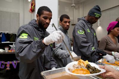 (From Left) Volunteers Lamont Peterson, Anthony Peterson and Barry Hunter help to serve Thanksgiving dinners at the Central Union Mission, Washington D.C.