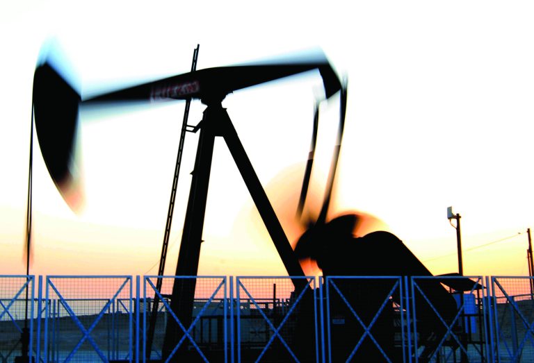 An oil pump works in the Sakhir, Bahrain, desert oil fields at sunset Tuesday, July 3, 2012. The price of oil jumped more than 4 percent Tuesday to the highest level since May on renewed fears of a military conflict with Iran. (AP Photo/Hasan Jamali)