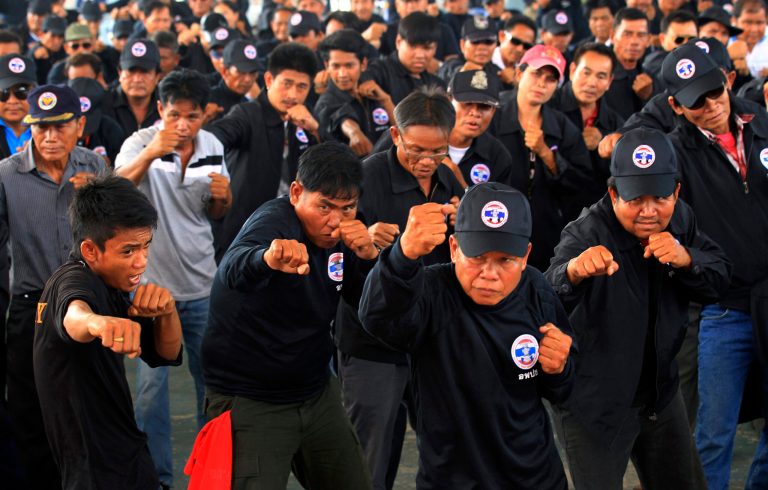 HOLD FOR STORY SLUGGED: THAILAND RED SHIRT RISING BY THANYARAT DOKSONE -  In this April 3, 2014 photo, Pro-government Red Shirt supporters perfform in  a Thai kickboxing exercise as part of a 2-day training course for security volunteers in the northeastern Udon Thani province Thailand . As caretaker Prime Minister Yingluck Shinawatra and her government are facing an array of legal challenges that could throw them out of office, the pro-government Red Shirts are stepping out to remind their opponents of their existence and that they are preparing for the worst.(AP Photo/Sakchai Lalit)