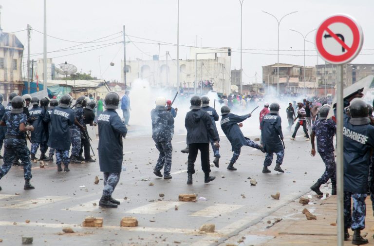   Security forces fire tear gas as they clash with anti-government protesters in Lome, Togo Tuesday, June 12, 2012. More than 10,000 protesters took to the streets of Togo's capital Tuesday to protest recent changes to the electoral code and to express their frustration over the government's failure to act to address long-standing grievances such as human rights violations by security forces. (AP Photo/Erick Kaglan)  