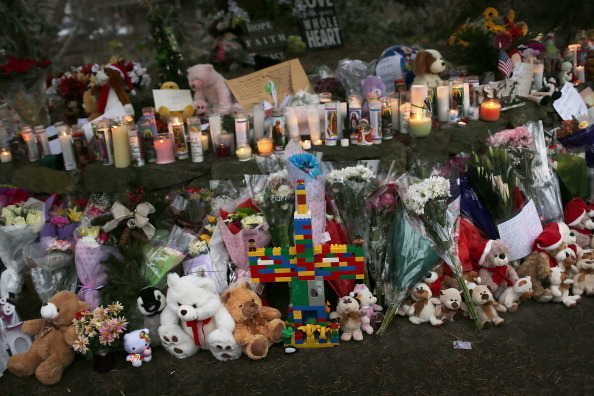 NEWTOWN, CT - DECEMBER 16:  Teddy bears, flowers and candles in memory of those killed, are left at a memorial down the street from the Sandy Hook School December 16, 2012 in Newtown, Connecticut. Twenty-six people were shot dead, including twenty children, after a gunman identified as Adam Lanza opened fire at Sandy Hook Elementary School. Lanza also reportedly had committed suicide at the scene. A 28th person, believed to be Nancy Lanza, found dead in a house in town, was also believed to have been shot by Adam Lanza.  (Photo by Spencer Platt/Getty Images)