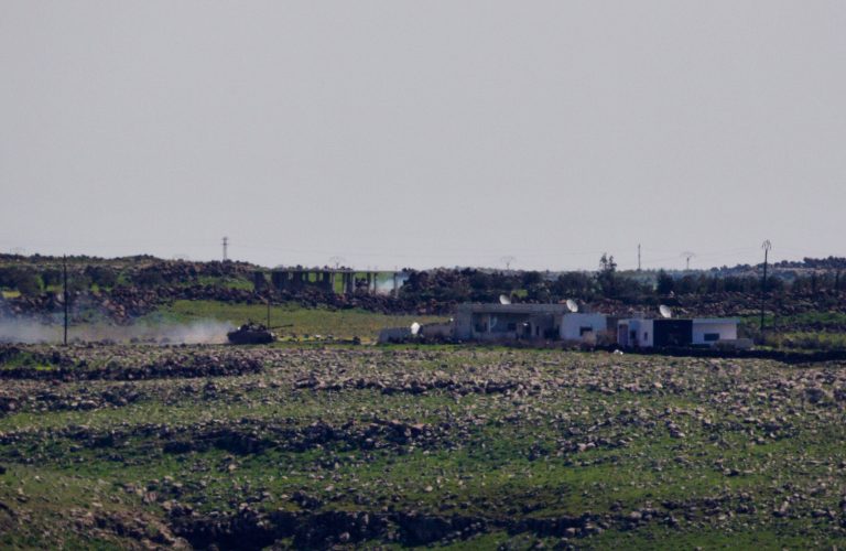 A Syrian Army tank moves towards the Syrian village of Jamlah in the southern province of Daraa, Syria, as seen from the Israeli-controlled Golan Heights ,Thursday, March 7, 2013. Clashes between Syrian troops and rebel fighters flared on Thursday near an area where armed fighters linked to the opposition abducted 21 U.N. peacekeepers a day earlier. The peacekeepers are part of a force that monitors a cease-fire between Israeli and Syrian troops in the Golan Heights. Israel captured part of the territory in the 1967 Mideast war, and while the area has been peaceful for decades, Israeli officials have grown increasingly jittery as the Syrian civil war moves closer to its borders. (AP Photo/Ariel Schalit)