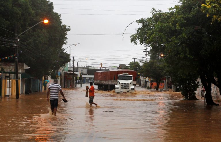 A truck makes it's way down a flooded street after heavy rain storms in Recife, Brazil, Thursday, June 26, 2014. The World Cup soccer match between the USA and Germany will be played at the Arena Pernambuco in Recife today.  (AP Photo/Petr David Josek)
