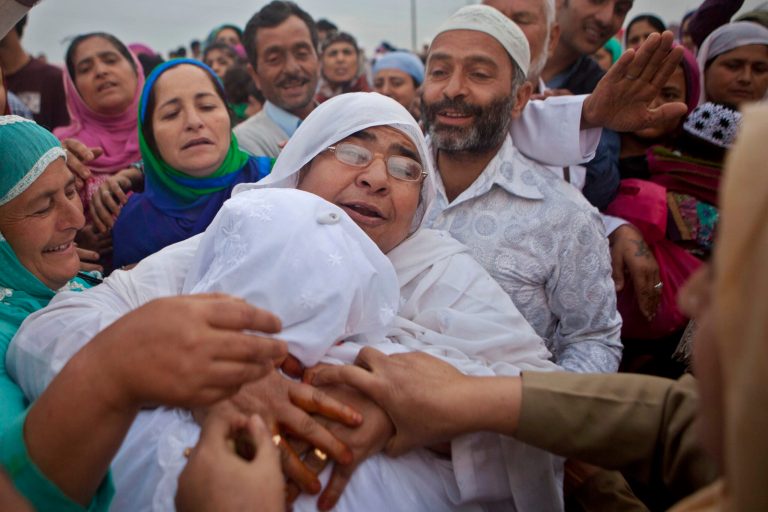 A Kashmiri Muslim pilgrim, back to camera, is hugged by her relative as she leaves for the annual hajj pilgrimage to the holy city of Mecca, in Srinagar, India, Wednesday, Aug. 27, 2014. The hajj pilgrimage, which is among the five pillars of Islam, attracts around 3 million Muslims worldwide each year. (AP Photo/Dar Yasin)