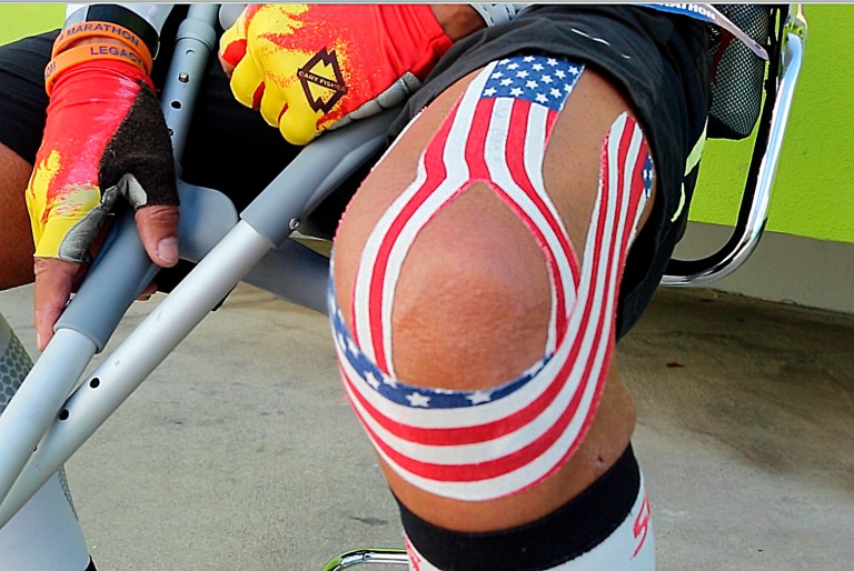Lou Briones rests his injured knee for a moment as he hobbles down Sunset Boulevard in West Hollywood, Calif., on Sunday, March 9, 2014. (AP Photo)Â 
