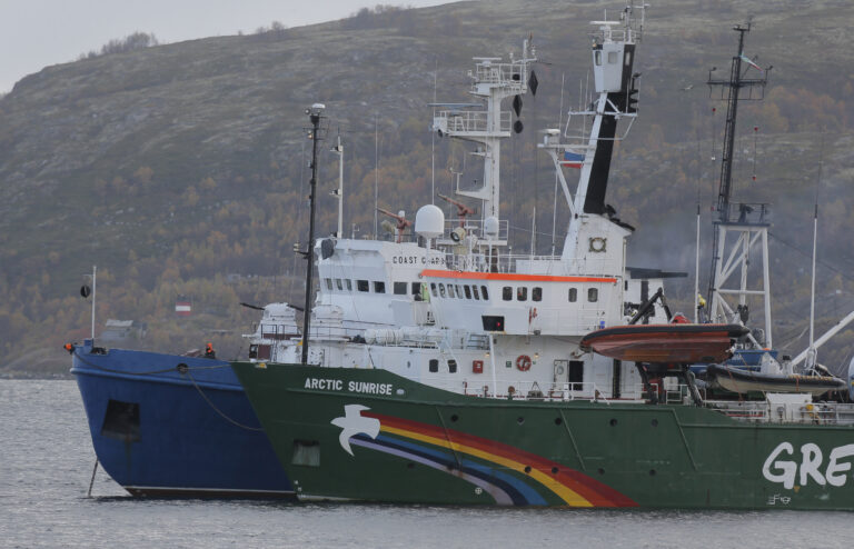 FILE - This is a Tuesday, Sept. 24, 2013.  file photo of  Greenpeace ship 'Arctic Sunrise'  as it is escorted by a Russian coast guard boat, in Kola Bay at the military base Severomorsk on the Kola peninsula in Russia. Greenpeace International says Russian authorities have informed the activist group they will release the ship Arctic Sunrise, which has been held in Murmansk since it was seized during a protest against an offshore oil platform in September 2013. Amsterdam-based Greenpeace said Friday  June 6, 2014 it still believes the actions of Russian authorities in seizing the ship and arresting 30 people on board were against international law.  (AP Photo/Efrem Lukatsky, File)