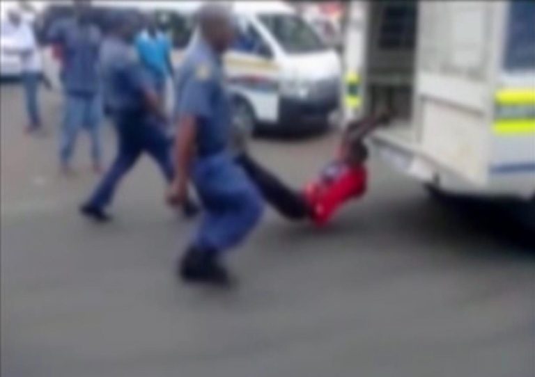 In this still frame from TV and courtesy of South African Daily Sun newspaper, showing a South African man with his hands tethered to the back of a police vehicle being dragged behind as police hold his legs up and the vehicle apparently drives off, east of Johannesburg Tuesday Feb. 26, 2013. The man died of his injuries. In video filmed on a mobile phone, uniformed police are seen trying to subdue the man, then tethering him to the back of a police vehicle which drives off, watched by a large crowd. Moses Dlamini of the Independent Police Investigative Directorate said early Thursday Feb. 28 2013 on ENCA TV network that his service has opened a murder probe. (AP Photo/The Daily Sun) TV OUT