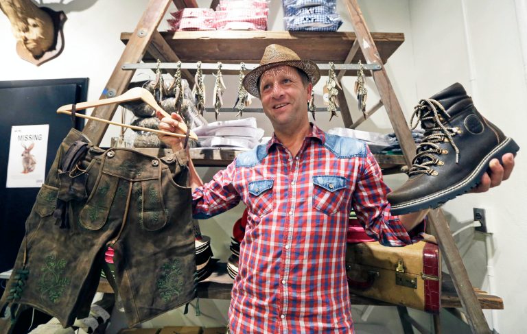 Michael Plangger, president of the German clothing store, Wiesnokoenig, poses inside his new flagship store, Wednesday, Aug. 20, 2014, located inside the Christian Moerlein Brewery in Cincinnati. (AP Photo/Al Behrman)