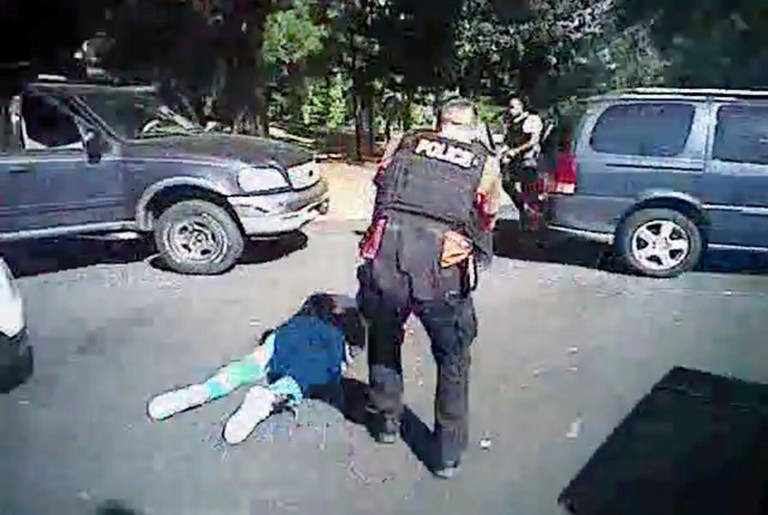 This image made from video provided by the Charlotte-Mecklenburg Police Department on Sept. 24 shows Keith Scott on the ground as police approach him in Charlotte, N.C., on Sept. 20, 2016. Charlotte-Mecklenburg District Attorney Andrew Murray announced Wednesday that the shooting by officer Brentley Vinson was justified. (Charlotte-Mecklenburg Police Department via AP)