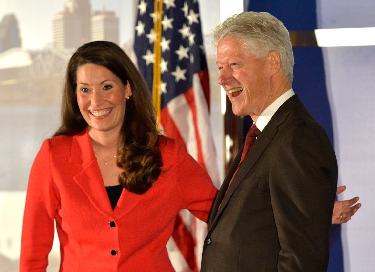 Democratic Senate challenger Alison Lundergan Grimes left, speaks with former Presidet Bill Clinton as they are introduced at a fundraiser at the Galt House Hotel, Tuesday, Feb. 25, 2014, in Louisville, Ky. (AP Photo/Timothy D. Easley)