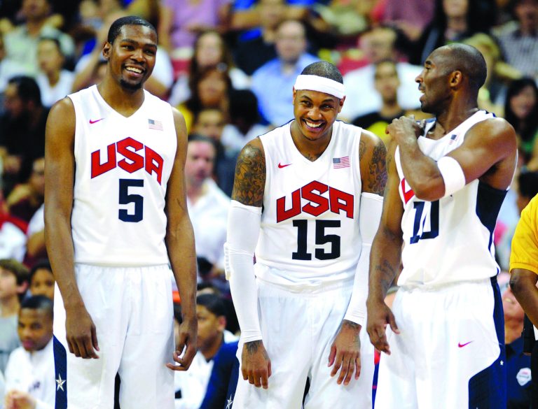 LAS VEGAS, NV - JULY 12:  Kevin Durant #5, Carmelo Anthony #15 and Kobe Bryant #10 of the US Men's Senior National Team chat on the sideline during a pre-Olympic exhibition game against the Dominican Republic at Thomas & Mack Center on July 12, 2012 in Las Vegas, Nevada. The United States won the game 113-59.  (Photo by David Becker/Getty Images)