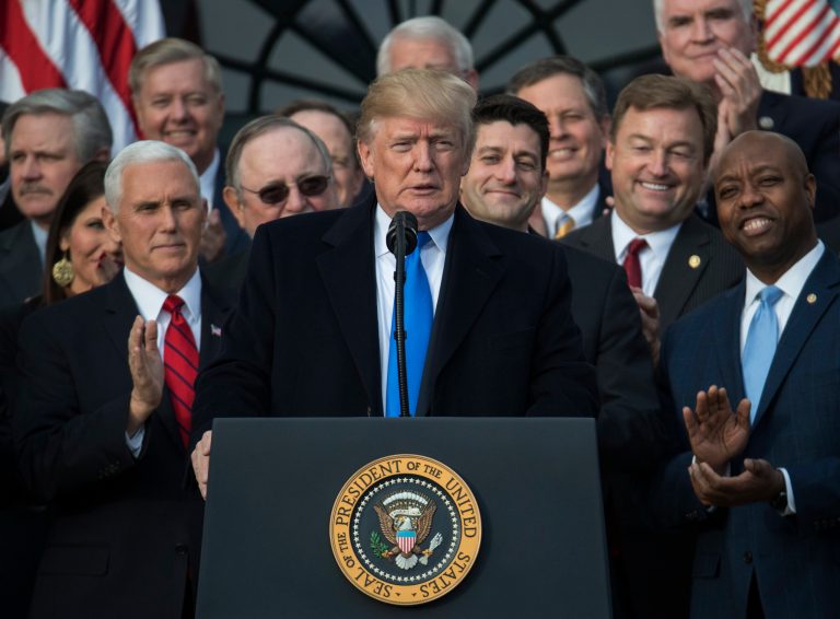 In this Dec. 20, 2017, photo, President Donald Trump, joined by Vice President Mike Pence, Speaker of the House Paul Ryan, R-Wis., and other members of Congress, pauses as he speaks during an event on the South Lawn of the White House in Washington, to acknowledge the final passage of tax overhaul legislation by Congress. (AP Photo/Carolyn Kaster)