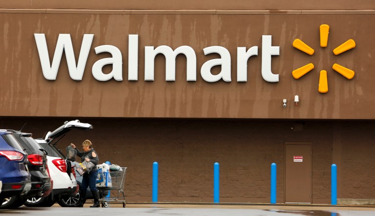 A shopper loads her car after shopping at a Walmart in Pittsburgh, Thursday, Feb. 22, 2018. According to a statement from the company, the decision to raise the minimum firearm purchasing age to 21 was reached 