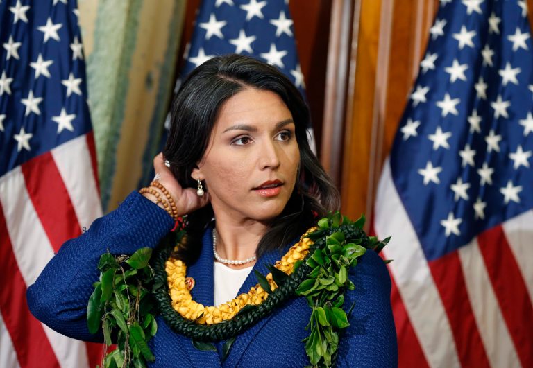 This Jan. 3, 2013, file photo shows Rep. Tulsi Gabbard, D-Hawaii, waiting for a photo with House Speaker John Boehner, of Ohio, on Capitol Hill in Washington.