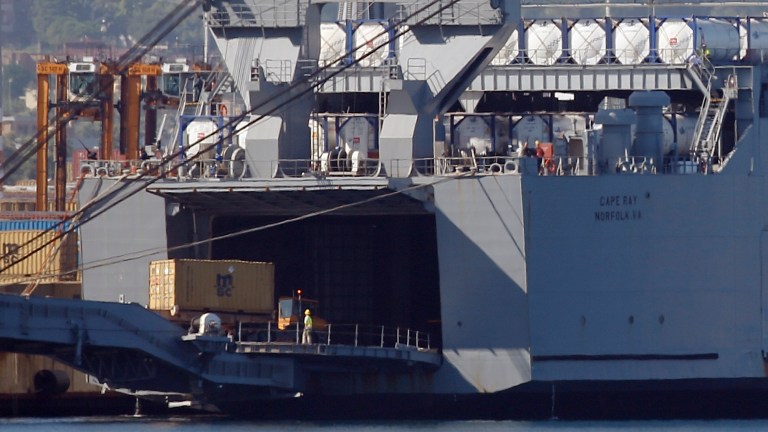 A truck carrying a container from the Danish vessel Ark Futura drives into the hold of the U.S.-owned MV Cape Ray, at Gioia Tauro port, southern Italy, Wednesday, July 2, 2014. A Danish ship carrying hundreds of tons of Syrian chemical weapons steamed into the southern Italian port for a rendezvous with a U.S. cargo vessel that will destroy the toxic material. (AP Photo/Luca Bruno)