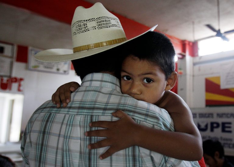 Miguel, 3, clings to his father, Miguel, an illegal immigrant, Friday, Aug. 27, 2010, in San Juan, Texas. Miguel and his wife, who remain in the U.S. as illegal immigrants, have two children born in the U.S. (AP Photo/Eric Gay)
