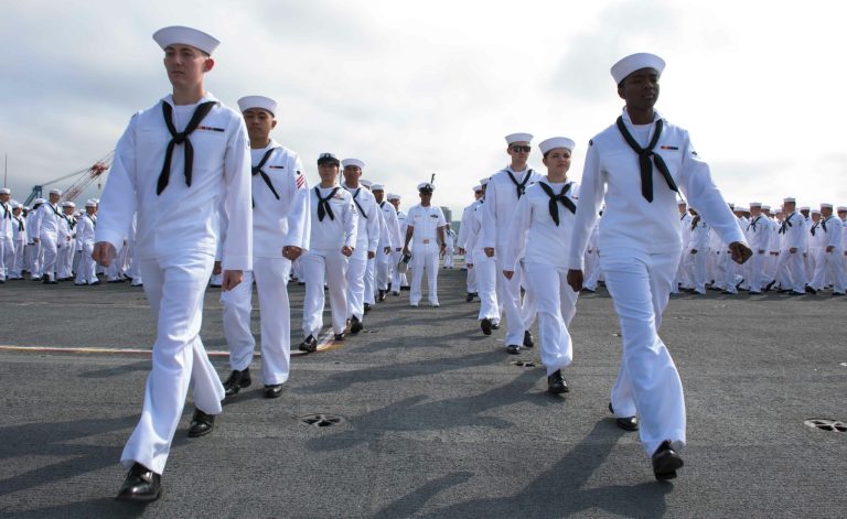 Sailors march to man the rails on the flight deck of the aircraft carrier USS Ronald Reagan as the ship left Yokosuka, Japan on Tuesday. (Navy photo)