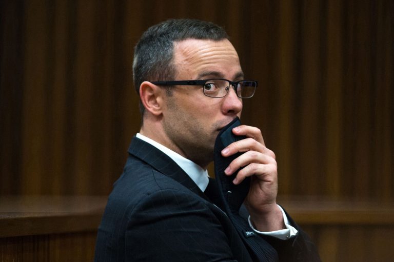File: In this Tuesday, May 13, 2014 file photo, murder accused Oscar Pistorius, looks sideways as he listens to psychiatric evidence for his defense, during his ongoing murder trial in Pretoria, South Africa. Presiding Judge Thokozile Masipa is expected to announce her verdict in Pistorius' murder trail after scrutinizing evidence Thursday and Friday given by 37 witnesses in a court transcript running to thousands of pages in a drama that has played out over six months.  (AP Photo/Daniel Born, Pool)