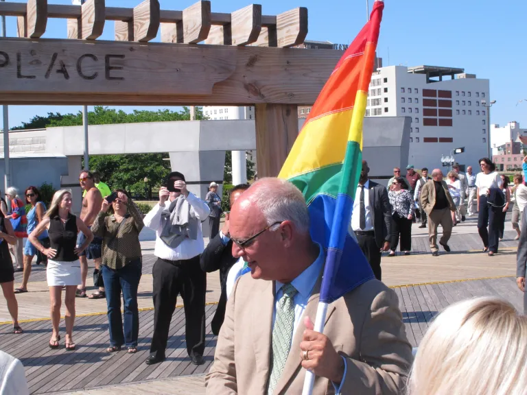 Atlantic City Mayor Don Guardian holds a flag in Atlantic City, N.J., Monday, June 16, 2014. Atlantic City is planning a series of events to attract gay tourists, who are becoming an increasingly important part of the resort's growth strategy. (AP Photo/Wayne Parry)