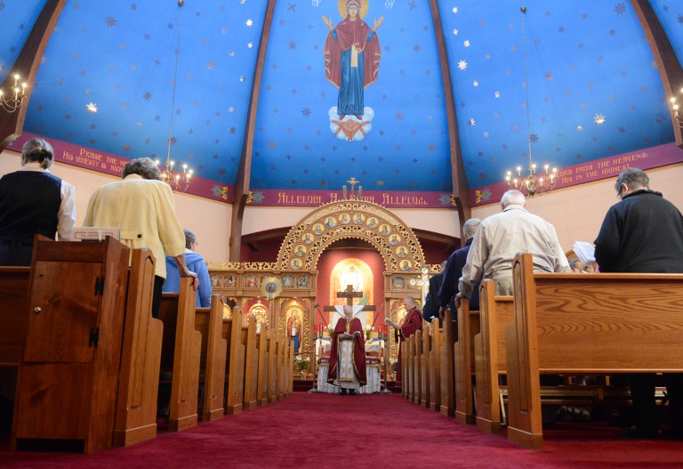 Monsignor Myron Grabowsky leads the prayer during St. Michael's Ukrainian Catholic Church's Easter Vigil service in Shenandoah, Pa. (David McKeown/Republican-Herald via AP)