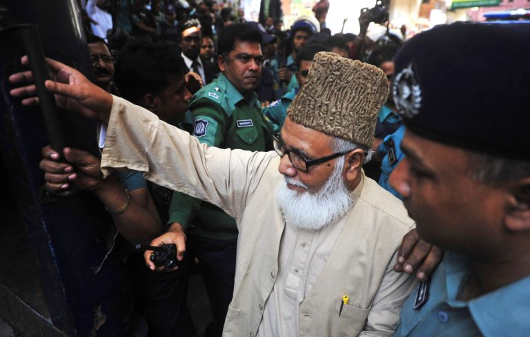 Matiur Rahman Nizami, head of the country's main Islamist opposition party Jamaat-e-Islami, enters a prison van at a court in Chittagong, Bangladesh, Thursday, Jan. 30, 2014. Nizami was among 14 people sentenced to death on Thursday on charges of smuggling weapons to a rebel group in neighboring India. (AP Photo/Khurshed Rinku)