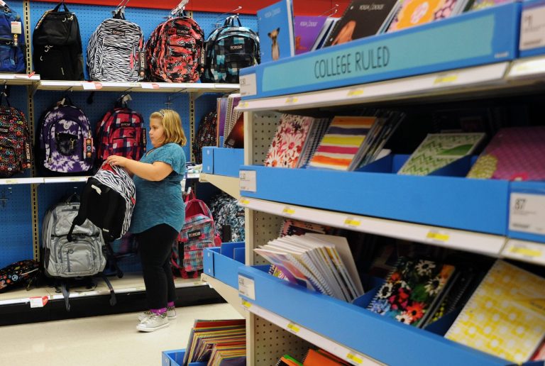   FILE - In this Friday, Aug. 2, 2013, file photo, Raegan Jackson, 10, picks out a backpack shopping at Target in Lynchburg, Va. The government reports on sales at U.S. retailers in August on Friday, Sept. 13, 2013. (AP Photo/News & Daily Advance, Sam O'Keefe)  