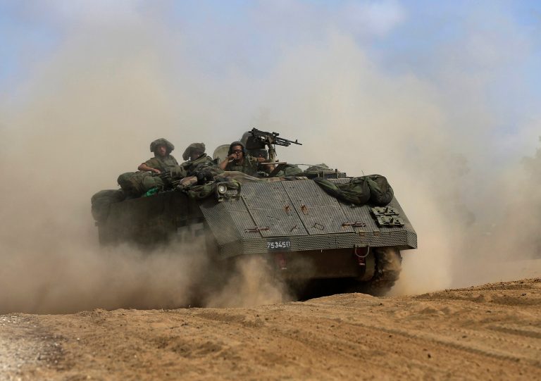 An Israeli armored personnel drives along the Israel and Gaza border, Sunday, July 13, 2014. (AP Photo/Tsafrir Abayov)