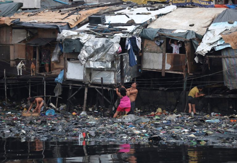 Residents strengthen their homes built on stilts as they brace for incoming Typhoon Rammasun, locally called 