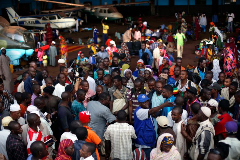 Chadian families wait for transport to Chad in a hangar at Bangui's airport in Bangui, Central African Republic, Thursday Jan. 30, 2014. Over 350 Muslim refugees were evacuated by the UN's International Organization for Migration (IOM) fleeing sectarian violence between Muslim Seleka forces and Christian anti Balaka militias. (AP Photo/Jerome Delay)