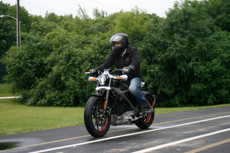 In this Wednesday, June 18, 2014 photo, employee Ben Lund demonstrates Harley's new electric motorcycle at Harley's research facility in Wauwatosa, Wis. The company plans to unveil the LiveWire model Monday, June 23, at an invitation-only event in New York. (AP Photo/M.L. Johnson)
