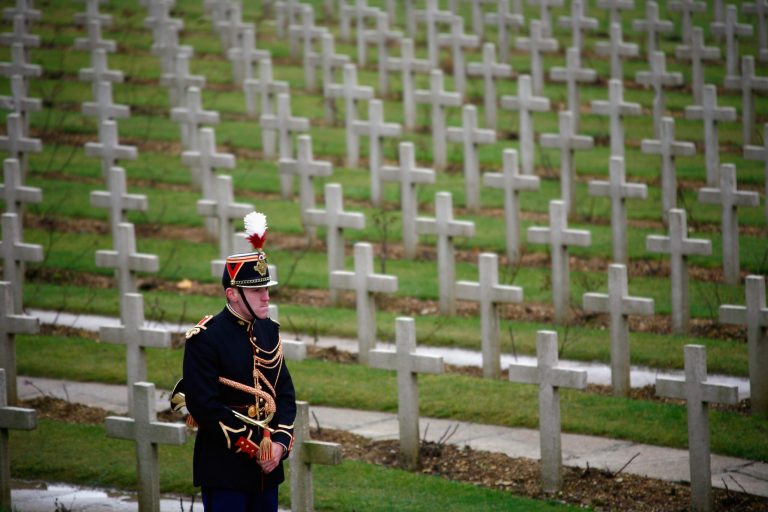 A lone French soldier stands amongst graves during commemorations of the 90th anniversary of the end of World War I on November 11, 2008 in Douaumont, France. (Photo by Julien M. Hekimian/Getty Images)