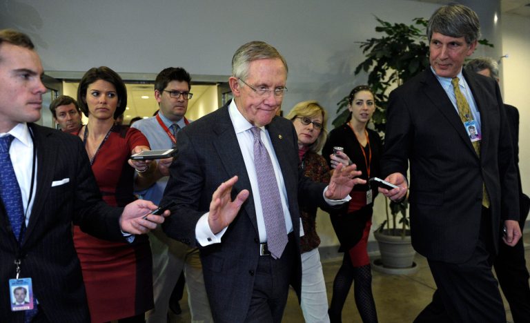 Senate Majority Leader Harry Reid of Nev., center, is pursued by reporters on Capitol Hill in Washington, Wednesday, Dec. 11, 2013, following a closed-door briefing on the recent agreement reached between Iran and western powers on Iran's nuclear program.  (AP Photo/Susan Walsh)