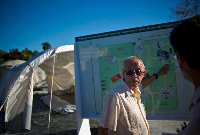 Jorge Perez, the head of Cuba's top tropical medicine institute, points to a map, showing the location of the field hospital set up to train doctors in the fight against Ebola, in Havana, Cuba, Friday, Oct. 17, 2014. Cuba has sent 165 doctors to Sierra Leone and plans to send 296 more to Liberia and Guinea, the largest commitment of medical personnel so far. Perez says Cuba is ready to send more doctors as long as there is enough funding and infrastructure to support them. (AP Photo/Ramon Espinosa)