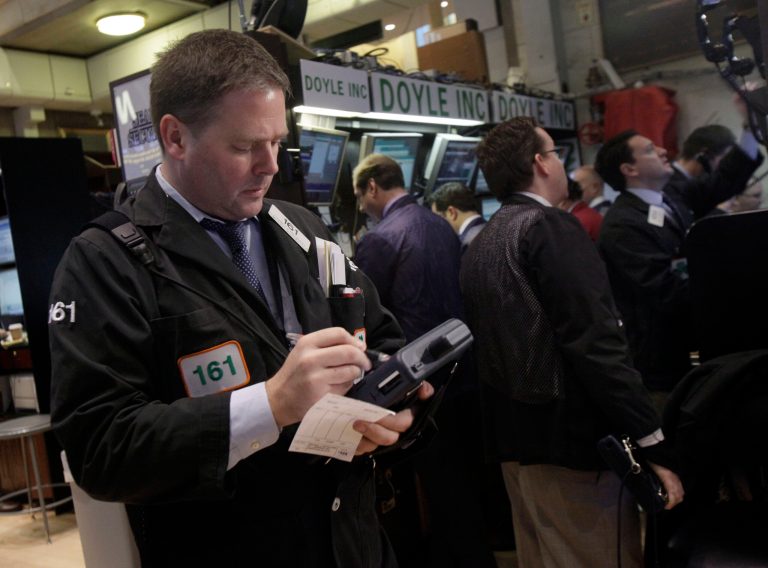   Trader Thomas McCauley, left, works on the floor of the New York Stock Exchange Thursday, Dec. 6, 2012. The U.S. stock market wobbled between small gains and losses in early trading Thursday. (AP Photo/Richard Drew)  