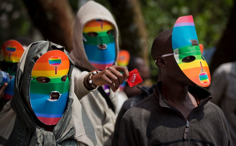 FILE - In this Feb. 10, 2014 file photo, Kenyan gays, lesbians and supporters wear masks to preserve their anonymity, as they stage a rare protest, against Uganda's increasingly tough stance against homosexuality outside the Uganda High Commission in Nairobi, Kenya. Human rights and gay rights activists on Tuesday, July 29, 2014, urged President Barack Obama to ensure that the issue of anti-gay discrimination in Africa is on the agenda at next week's summit in Washington with more than 40 African leaders. (AP Photo/Ben Curtis, File)