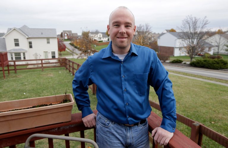U.S. Marine veteran Gary Staten poses on the deck outside his home, Thursday, Nov. 21, 2013, in Hebron, Ky. Staten credits staff at Easter Seals TriState for helping him find a job with FedEx just weeks after his recent military discharge and for his wife's temporary job. The nonprofit Easter Seals organization is in the midst of a new initiative to expand support networks for veterans, military service members and their families. (AP Photo/Al Behrman)