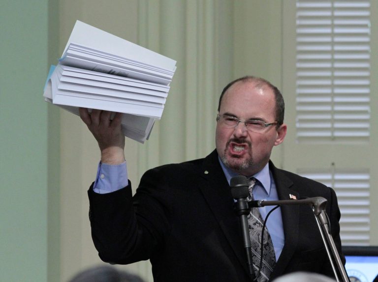   Assemblyman Tim Donnelly, R-Twin Peaks, holds up a copy of the state budget as he urges lawmakers to reject the 2012-13 spending plan at the state Capitol in Sacramento, Calif., Friday, June 15, 2012. Despite opposition by Republicans, the Assembly approved the budget 50-25 and sent it to the governor. (AP Photo/Rich Pedroncelli)  