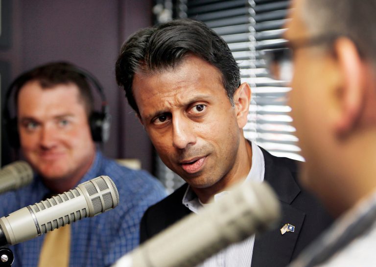 Republican presidential candidate Gov. Bobby Jindal, R-La., center talks with radio show hosts Dean Spiliotes , right, and Chris Ryan during the taping of Pints and Politics radio show with WKXL at the Barley House restaurant Tuesday, July 7, 2015, in Concord, N.H. (AP Photo/Jim Cole)