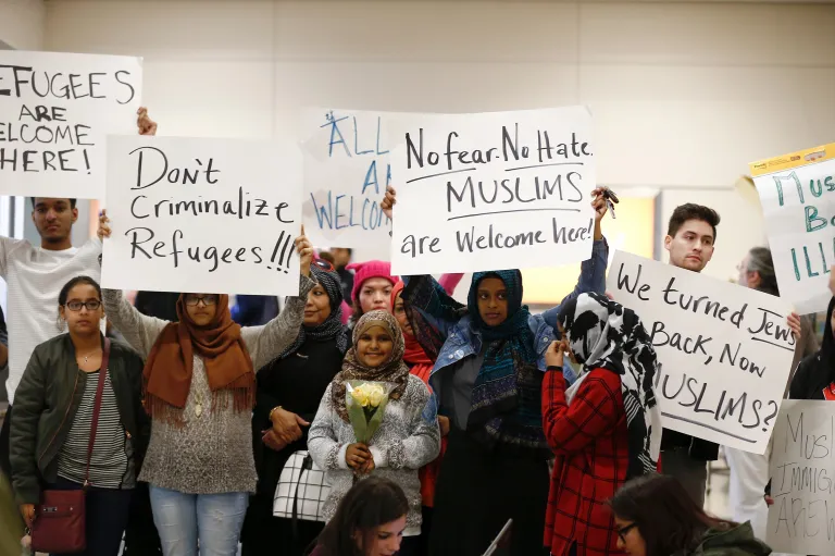 Protesters demonstrate against President Trump's executive order at the Dallas Forth Worth Airport. (Brandon Wade/Star-Telegram via AP)