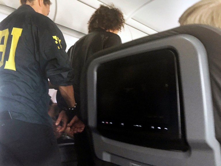 Federal agents met the plane when it landed in Honolulu and the suspect was taken into custody where he is expected to face federal charges. (Donna Basden via AP)