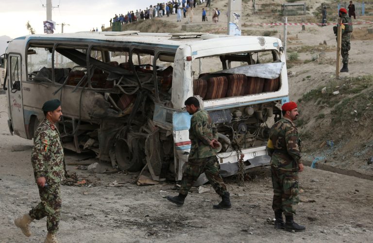Afghan National army soldiers arrive to the scene after suicide attack in Kabul, Afghanistan, Monday, May 26, 2014. A suicide bomber riding a motorcycle on Monday killed at least two Afghan defense ministry staffers and wounded at least several others after he rammed a bus carrying soldiers and civilian employees who were returning home from work. (AP Photo/Rahmat Gul)