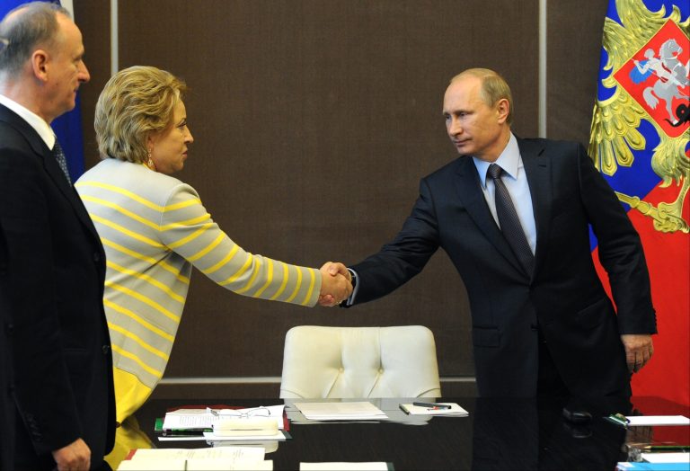 Russian President Vladimir Putin shakes hands with upper parliament chamber speaker Valentina Matviyenko prior to the Security Council meeting in the Russian Black Sea resort of Sochi on Monday, May 19, 2014. Russian President Vladimir Putin has ordered troops deployed in regions near Ukraine to return to their home bases, the Kremlin said Monday. (AP Photo/RIA Novosti Kremlin, Mikhail Klimentyev, Presidential Press Service)