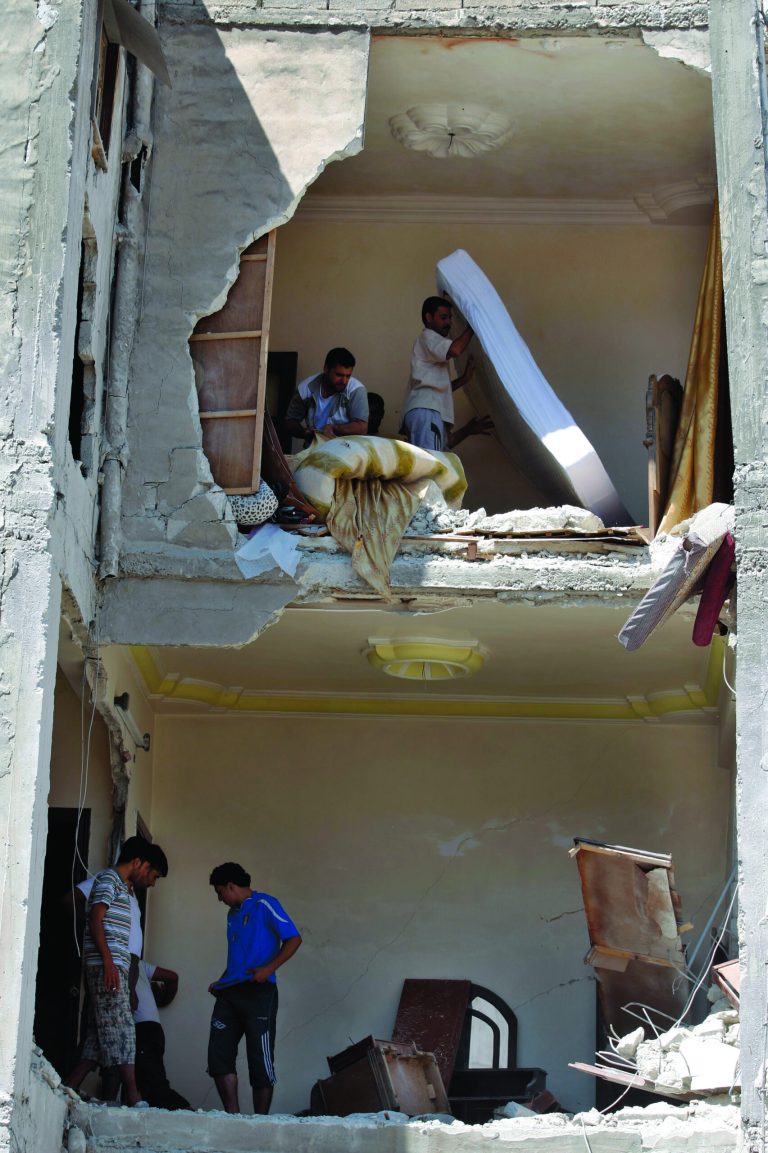 Syrians salvage what they can of their belongings from a building that was hit during a Syrian government airstrike in Aleppo, Syria, Sunday, Aug. 19, 2012 (AP Photo/ Khalil Hamra)